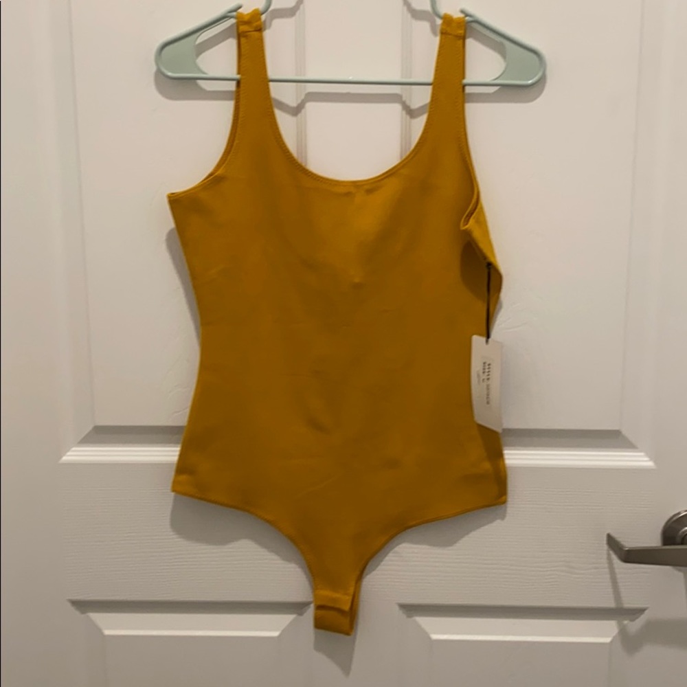 New with tags yellow body suit